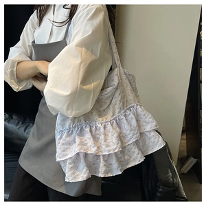 Detailed shot of lavender floral tote bag with elegant double ruffles and soft fabric texture