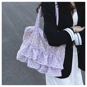 Detail view of lavender floral tote bag with tiered ruffles and long shoulder straps