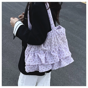 Detail of purple floral bucket bag with multi-layer ruffled texture and sweet vintage style