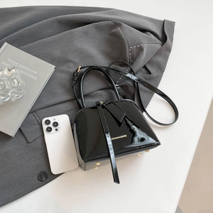 Glossy black shell-shaped handbag with golden text and detachable shoulder strap