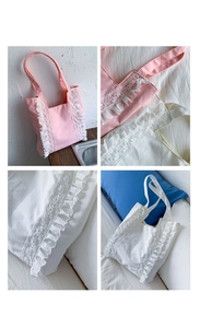 Detail of pink and white canvas tote bags with delicate lace trim and ruffle accents