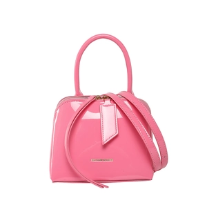 Glossy pink shell-shaped crossbody bag with top handle and adjustable shoulder strap