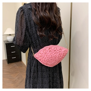 Pink hand-woven shoulder bag featuring a fan-shaped crochet texture and gold chain strap