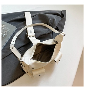 Detail of white PU leather punk bag featuring multi-pockets and metal grommet strap