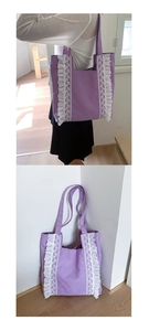 Close-up of purple canvas tote bag featuring decorative white lace trim and ruffle details