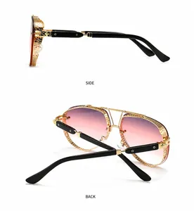 Detailed side view of hollow-out gold metal frame sunglasses with gradient pink lenses