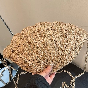 Summer woven straw shell-shaped crossbody bag with golden chain strap for beach vacations