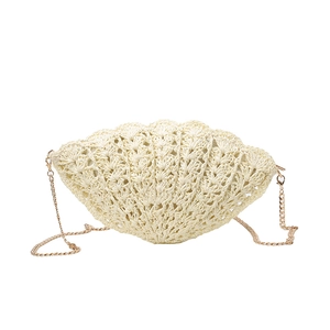 Chic beige woven shell-shaped crossbody bag with a delicate gold chain strap for summer