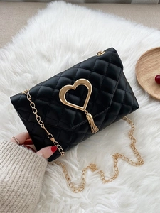 Elegant black quilted heart-shaped crossbody bag with gold chain and fringe detail