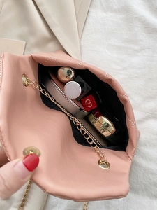 Pink quilted heart-shaped chain bag with gold hardware and interior storage space