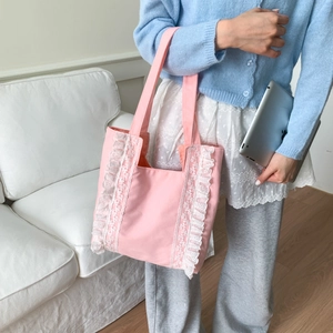 Pink canvas tote bag with white lace trim and ruffles, perfect for daily commute or campus