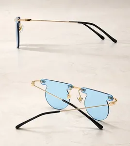 Detail view of gold metal sunglasses with blue transparent lenses showing side and back angles