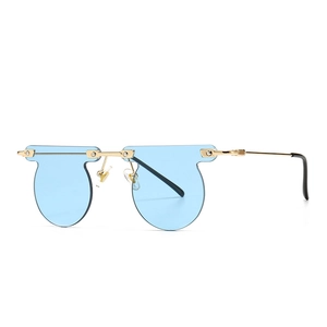 Chic rimless round sunglasses with light blue lenses and gold metal frame on white background