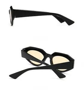 Detail view of black geometric sunglasses with amber lenses showing side and back profiles