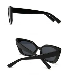 Side and back view detail of modern black cat-eye sunglasses with polished frame