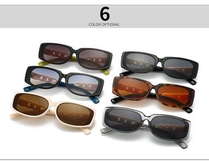 Detail view of rectangular sunglasses in six colors with chain cutout temple design
