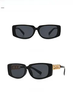 Close-up view of black square sunglasses with decorative bold gold chain temples