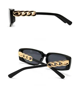 Detail showing bold gold chain temple design on black rectangle sunglasses frame