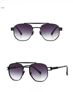 Detail view of aviator sunglasses with black metal frame and gradient grey lenses