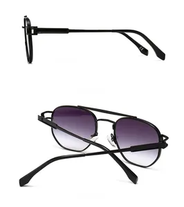 Detail view of double-bridge aviator sunglasses with black frame and purple gradient lenses