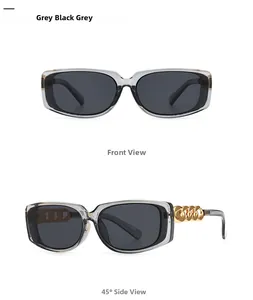 Detail view of rectangular sunglasses featuring distinctive gold metal chain link temples