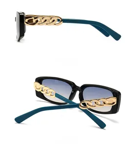 Detail of square sunglasses featuring navy blue temples with gold chain link decoration