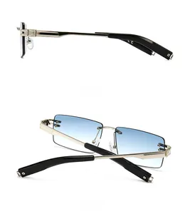 Detail view of rimless sunglasses with blue gradient lenses and golden metal temples
