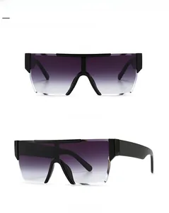 Detail view of oversized black frame sunglasses with double grey gradient lenses