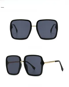 Front and 45-degree side views of black square sunglasses with gold metal accents