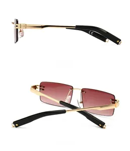 Detail view showing frameless gradient brown lenses and golden metal temples of sunglasses