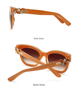 Détail de la monture orange avec décoration florale en strass ambrés sur la branche