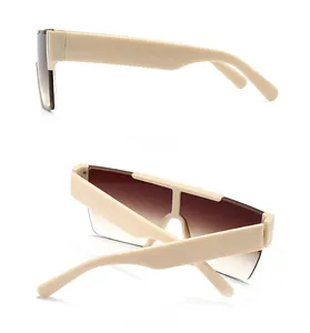 Detail view showing side and back of beige flat top sunglasses with brown gradient lenses