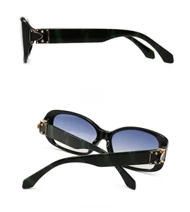 Detail of vintage square sunglasses with green marble temples and gold cross ornaments