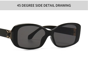 Close-up of black square sunglasses with decorative gold hinge detail at a 45-degree angle