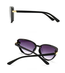 Side and back view of oversized cat-eye sunglasses with gold temples and purple lenses