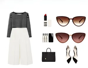 Flat lay showing cat-eye sunglasses with striped top, trousers, and leather handbag