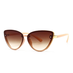 Modern cat-eye sunglasses with light pink frame and gold glitter trim on gradient brown lenses