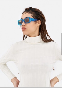 Close-up of stylish blue square frame sunglasses with light brown lenses on a model