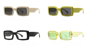 Detail view of colorful rectangular retro sunglasses in beige green black and yellow