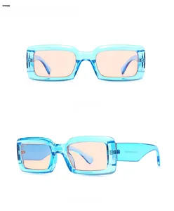 Detail view of retro rectangle sunglasses featuring blue transparent frames and orange lenses