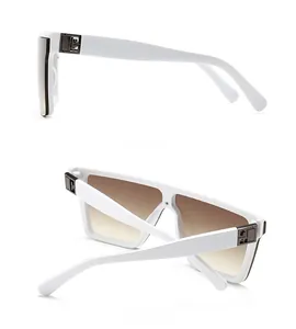 Detail view of white wide-frame sunglasses with brown gradient lenses and metal logo