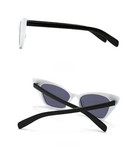 Side and back view of retro cat-eye sunglasses featuring white frames and black temples