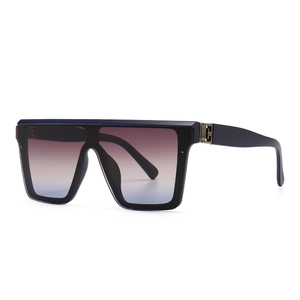 Flat top navy blue oversized sunglasses with gradient lenses in a 45-degree side view