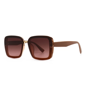 Modern oversized square sunglasses with amber frames and brown gradient lenses