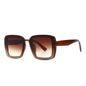 Square fashion sunglasses with brown gradient lenses and gold glitter frame detail