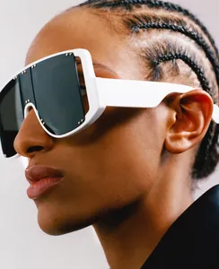 Close-up of white oversized shield sunglasses with silver studs on the temple