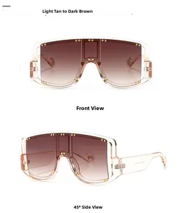 Oversized shield sunglasses featuring light tan gradient lenses and gold rivet accents