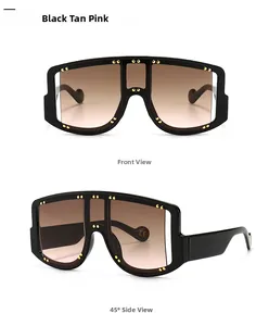 Macro detail of black oversized shield sunglasses with gold rivets and pink lenses