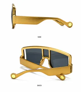 Detail view of gold oversized shield sunglasses with grey lenses and studded temples