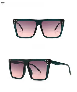 Detail of square green sunglasses with gradient pink-grey lenses and triple metal rivets